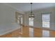 Traditional dining room with hardwood floors, white molding, and a decorative chandelier for elegant dinners at 1871 Birch Briar Bnd, Lawrenceville, GA 30043