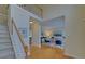 Bright foyer with hardwood floors, staircase and a view into the living room or office space at 1871 Birch Briar Bnd, Lawrenceville, GA 30043