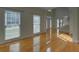 Bright foyer featuring gleaming hardwood floors, a staircase, and an entry door at 1871 Birch Briar Bnd, Lawrenceville, GA 30043