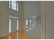 Bright two-story foyer with hardwood floors, staircase, white door, and transom window above at 1871 Birch Briar Bnd, Lawrenceville, GA 30043