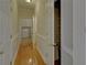 Bright hallway boasts hardwood floors, beadboard detail, and a laundry area at the end at 1871 Birch Briar Bnd, Lawrenceville, GA 30043