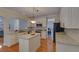 Modern kitchen featuring granite counters, stainless appliances, an island, and white cabinets for a clean look at 1871 Birch Briar Bnd, Lawrenceville, GA 30043