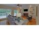 Cozy living room featuring a fireplace, built-in shelving, and large windows for natural light at 1871 Birch Briar Bnd, Lawrenceville, GA 30043