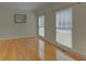 Cozy living room featuring hardwood floors and dual windows offering natural light at 1871 Birch Briar Bnd, Lawrenceville, GA 30043