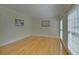 Empty living room featuring hardwood floors and natural light from the dual windows at 1871 Birch Briar Bnd, Lawrenceville, GA 30043