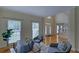 Sunlit living room featuring hardwood floors, large windows, and comfortable seating at 1871 Birch Briar Bnd, Lawrenceville, GA 30043