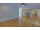 Open living room featuring hardwood floors and view into kitchen at 1871 Birch Briar Bnd, Lawrenceville, GA 30043