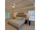Spacious main bedroom featuring a tray ceiling, ceiling fan, and sitting area at 1871 Birch Briar Bnd, Lawrenceville, GA 30043