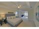 Comfortable main bedroom showcasing a tray ceiling, neutral tones, and a lounge area at 1871 Birch Briar Bnd, Lawrenceville, GA 30043