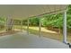 Covered patio offering shade and a view of the lush, wooded backyard at 1871 Birch Briar Bnd, Lawrenceville, GA 30043