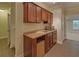 Wet bar area featuring wood cabinets and tile countertops at 1871 Birch Briar Bnd, Lawrenceville, GA 30043