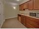 Wet bar with built-in mini fridge and tile countertops at 1871 Birch Briar Bnd, Lawrenceville, GA 30043