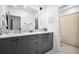 Well-lit bathroom features double vanity, marble countertops, modern fixtures, and stylish gray cabinets at 24 Becker Nw Pl, Atlanta, GA 30307