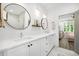 Bright bathroom features double sinks, modern fixtures, white cabinets, and stylish mirrors and lighting at 24 Becker Nw Pl, Atlanta, GA 30307