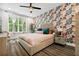 Stylishly designed bedroom featuring a floral accent wall, a ceiling fan, and lots of natural light at 24 Becker Nw Pl, Atlanta, GA 30307