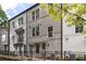 Well-maintained townhome exteriors featuring a black fence, a pergola, and greenery at 24 Becker Nw Pl, Atlanta, GA 30307