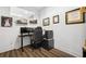 Home office with large monitor setup, floating shelves, and laminate floors at 24 Becker Nw Pl, Atlanta, GA 30307