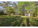 Lush backyard with mature trees offering shade and seclusion from neighboring houses at 2531 Ridgecrest Nw Dr, Kennesaw, GA 30152