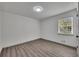 A bright bedroom offers wood-look laminate flooring and a large window with backyard views at 2531 Ridgecrest Nw Dr, Kennesaw, GA 30152