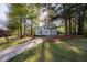 A well-maintained home set back from the street, surrounded by mature trees and green lawn at 2531 Ridgecrest Nw Dr, Kennesaw, GA 30152