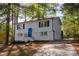 Charming home featuring a bright blue front door and neutral color palette, surrounded by mature trees at 2531 Ridgecrest Nw Dr, Kennesaw, GA 30152