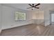 Bright living room with hardwood floors, modern ceiling fan, and black iron banister at 2531 Ridgecrest Nw Dr, Kennesaw, GA 30152