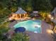 Aerial view of the pool, waterfall, gazebo, and backyard area at night at 4140 Hillside Nw Pl, Atlanta, GA 30342
