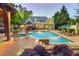 Spacious backyard with a pool, gazebo, lounge chairs, and mature trees at 4140 Hillside Nw Pl, Atlanta, GA 30342