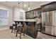 Basement wet bar features dark wood cabinetry, glass door cupboards, and granite countertops at 4140 Hillside Nw Pl, Atlanta, GA 30342
