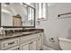 Updated bathroom with marble counters, and a window with blinds at 4140 Hillside Nw Pl, Atlanta, GA 30342