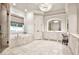 Luxurious bathroom with marble floors, soaking tub, and dual vanity sinks at 4140 Hillside Nw Pl, Atlanta, GA 30342
