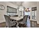 Elegant dining room with modern chandelier, large windows, and wood floors at 4140 Hillside Nw Pl, Atlanta, GA 30342