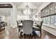 Bright dining room with hardwood floors, a crystal chandelier, and bench seating at 4140 Hillside Nw Pl, Atlanta, GA 30342