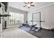 Home gym features window, television, rubber flooring, weight rack, and workout accessories at 4140 Hillside Nw Pl, Atlanta, GA 30342