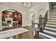 Grand entrance with wood floors, arched entryways, and a view of the home office at 4140 Hillside Nw Pl, Atlanta, GA 30342