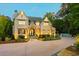 Stunning brick home featuring manicured landscaping and a large driveway at 4140 Hillside Nw Pl, Atlanta, GA 30342