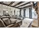 Spacious living room with wood beams, stone fireplace, and lots of natural light at 4140 Hillside Nw Pl, Atlanta, GA 30342