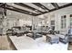 Open living area with exposed beams, stone fireplace, and comfortable seating at 4140 Hillside Nw Pl, Atlanta, GA 30342