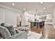 Open-concept living space with a view into a bright kitchen and stylish furnishings at 4140 Hillside Nw Pl, Atlanta, GA 30342
