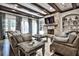 Comfortable living room featuring a stone fireplace and beautiful ceiling beams at 4140 Hillside Nw Pl, Atlanta, GA 30342
