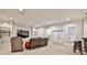 Spacious living room with built-in shelving, a large television, and sliding doors to the outside at 4140 Hillside Nw Pl, Atlanta, GA 30342