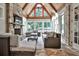 Cozy sunroom with stone accent wall, vaulted wood ceilings, and lots of natural light at 4140 Hillside Nw Pl, Atlanta, GA 30342