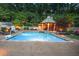 Backyard pool features a gazebo, lounge chairs, basketball hoop, and professional landscaping at 4140 Hillside Nw Pl, Atlanta, GA 30342