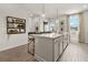 Kitchen island featuring a quartz countertop, storage cabinets, seating, and pendant lighting at 104 Holt Ln, Lawrenceville, GA 30046