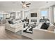 Airy living room featuring comfortable sofas, a fireplace, and hardwood floors at 104 Holt Ln, Lawrenceville, GA 30046