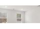 Bright bedroom with two windows providing natural light, freshly painted white walls at 225 Kenoot Dr # 50, Mcdonough, GA 30253