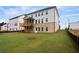 A spacious backyard features lush grass and a covered porch at 6935 Melody Ridge Rd, Buford, GA 30518