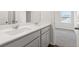 Bathroom boasts a marble countertop, dual sinks and a view into the carpeted bedroom at 6935 Melody Ridge Rd, Buford, GA 30518