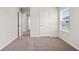 A spacious bedroom offers plush carpeting, and bright white doors with trim at 6935 Melody Ridge Rd, Buford, GA 30518