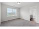 Carpeted bedroom with a light fixture, a large window, and a glimpse into the bathroom at 6935 Melody Ridge Rd, Buford, GA 30518